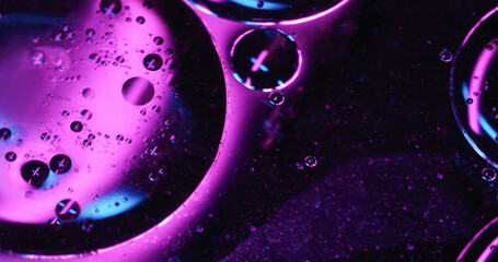 Molecular texture. Oil background. Defocused blue purple neon colorful drop sequins round water...