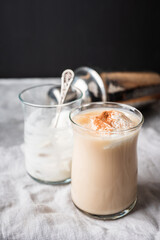 Coffee with ice cream and cinnamon in glass cup. Selective focus.