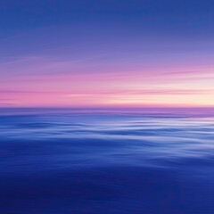Obraz premium A serene ocean view at sunset, showcasing beautiful hues of purple and blue reflecting on calm water.
