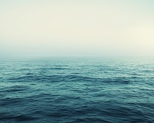 Obraz premium A serene view of calm water under a gentle sky, evoking tranquility and peace in nature.