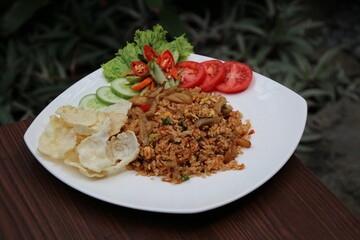 fried rice with chicken and cracker white plate