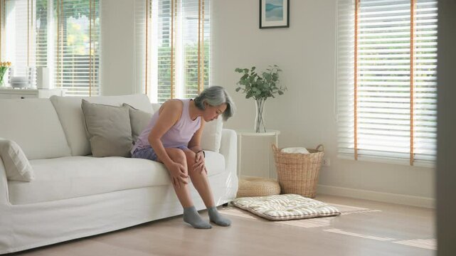 Asia adult people middle age old woman itch leg arm elbow body dry skin hand touch neck stress sad pain sit at home elder health care aging beauty illness issue. Asian female aged mosquito bite itchy.