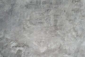 A close-up shot of a raw, textured concrete surface with a gray, industrial feel.