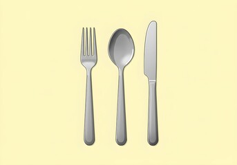 Arrangement of Fork Spoon and Knife on a Light Yellow Background