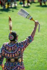 Woman in traditional regalia at a pow wow 