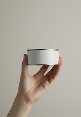 Hand Holding Plain Canned Tuna on Neutral Background - Minimalist and Modern