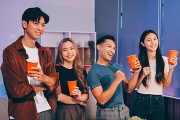 Happy young friends group having lunch at home. Asia family party eating pizza food and laughing enjoying meal while sitting at dining table together at house. Celebration holiday and togetherness.
