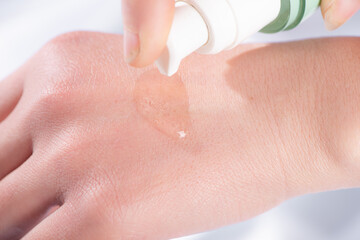 cosmetic moisturizer water molecule, Cosmetic Essence swatch on woman hand 