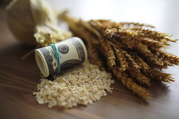 The concept of the cost of grain. 5000 ruble banknotes around a handful of ground grain. World...