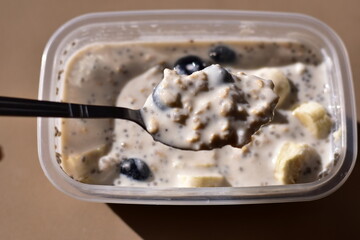 a healthy breakfast of overnight oats with milk, A bowl of overnight oats