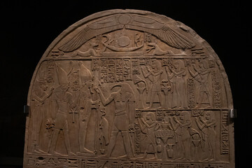 ancient Egyptian carvings and hieroglyphs on sand stones at the Grand Egyptian Museum in Cairo, Egypt