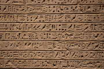 ancient Egyptian carvings and hieroglyphs on sand stones at the Grand Egyptian Museum in Cairo, Egypt