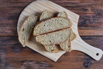 cross section of  homemade wholegrain bread slices on cutting board
