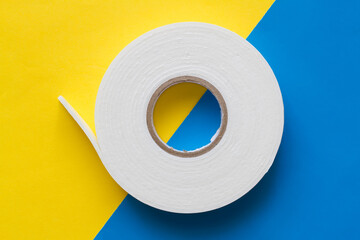 Double-stick foam tape. A roll of double-sided tape.