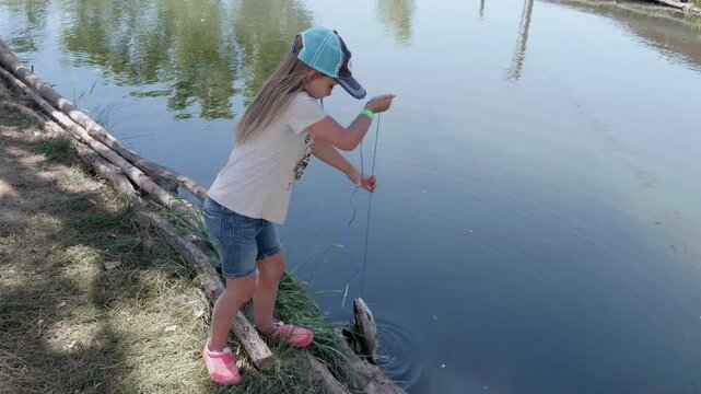 Little Girl Proud of Her Catch from Fishing