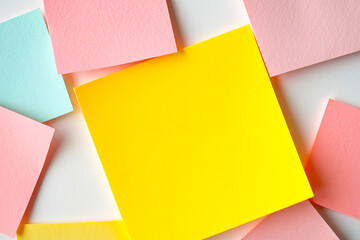 Fototapeta premium Flat lay of colorful notes with yellow mockup note on white background