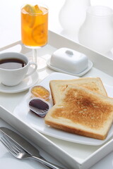 toast with jam white plate hot tea english breakfast