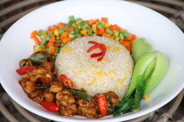 fried rice with mixed vegetables on white plate