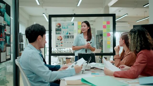 Group of young Asian business people team meeting in modern office working design planning and ideas concept