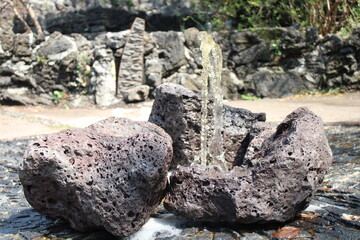 Jet of water emerges from volcanic rocks
