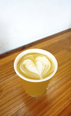 Hot latte coffee cup on wooden table