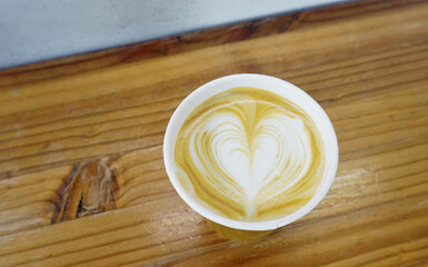 Hot latte coffee cup on wooden table