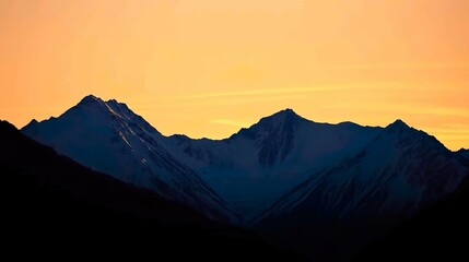 Capture the serene and majestic beauty of a snow-capped mountain landscape, with towering peaks glistening under a soft winter sun.