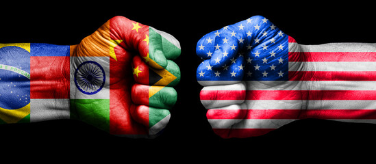 american flag fist against brics countries flag fist. concept of us versus brics group in business and trade war