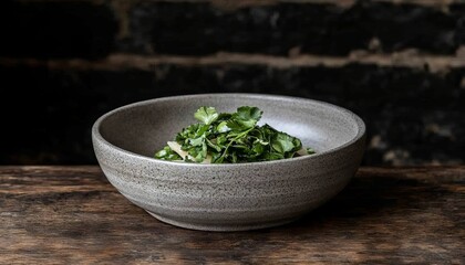 Grey Bowl of Fresh Greens on Wooden Table, Dark Brick Background