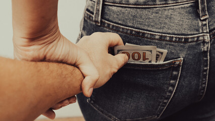 Money in the pocket. Stealing money Concept finance with Bundle of dollar. Human hand taking money...