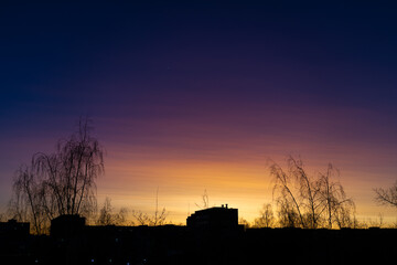 Sunset in the city. The gradient of colors from yellow to purple