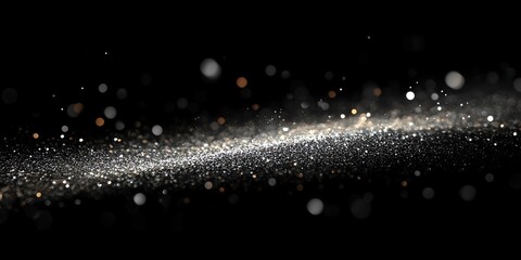 Floating glitter particles with bokeh on black background for elegant design