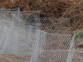 Gabion baskets for stone containment resist erosion and aging.