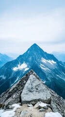 Mountain peak summit, rocky outcrop, snow, cloudy sky, inspirational