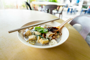 Close up of a bowl of curry mee or noodle in thick spicy gravy soup which is popular in Malaysia...