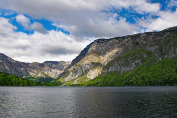 Scenic view of Lake Bohinj with mountains and cloudy sky in the background, showcasing the beautiful nature of Slovenia