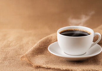 Fototapeta premium a cup of black coffee with steaming hot beans on the table,