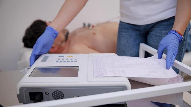 A healthcare professional conducting a cardiology test on a patient using an electrocardiogram device, monitoring heart activity for diagnosis and health assessment in a clinical setting