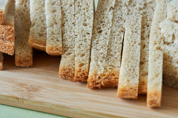 Slices of bread on wooden cutting board, food closeup