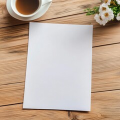 A serene workspace featuring a cup of coffee, a blank sheet of paper, and delicate flowers on a rustic wooden table.