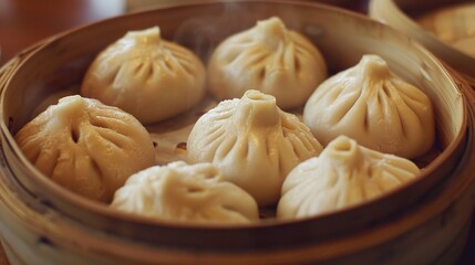 A close-up view of delicious baozi is shown. The baozi, with their soft and fluffy dough skins, come in various fillings, such as savory minced meat, flavorful vegetables, or a combination of both. 