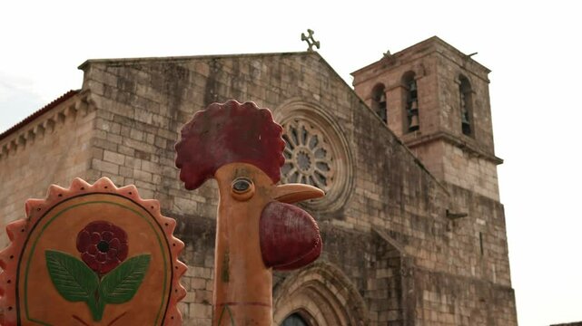 Igreja Matriz de Barcelos with a traditional Portuguese rooster sculpture in the foreground