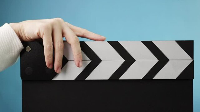 Closeup of a clapperboard, filmmaking scene, director marking a new take in production
