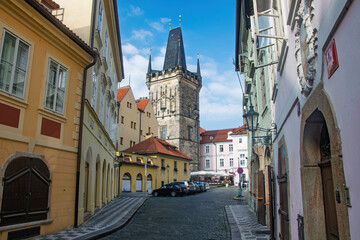 Jindrisska Tower standing tall over the charming cobblestone streets and colorful buildings of Prague, Czech Republic, on a clear sunny day