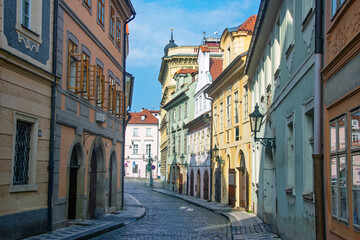 Cobblestone street winding through colorful buildings in Prague, Czech Republic, showcasing European architecture