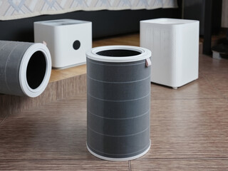 Disassembled electric floor air purifier in the bedroom. Replacing the old dusty filter with a new one.