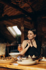 Elegant Woman Enjoying a Meal in a Cozy Rustic Restaurant Setting