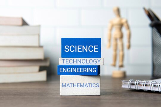 Four stacked blocks with a word representing a STEM field – "SCIENCE," "TECHNOLOGY," "ENGINEERING," and "MATHEMATICS". Education concept.