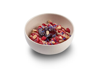 A bowl of oatmeal porridge with berries, nuts, and edible flowers, perfect for a healthy breakfast.