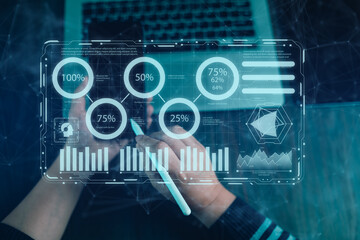 Futuristic data visualization concept featuring holographic charts, graphs, calendar, and a world map displayed above a laptop. Perfect for themes on technology, data analysis, and digital innovation.